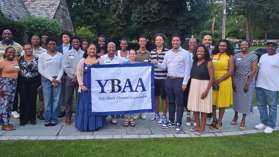 YBAA New York alumni and incoming students behind a YBAA banner at the New York Summer Send-Off